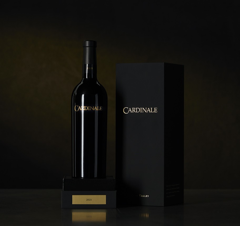 Wine bottle next to a wine box on a platform