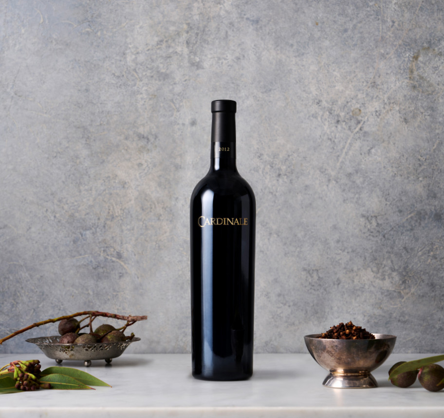 Single wine bottle against a gray background